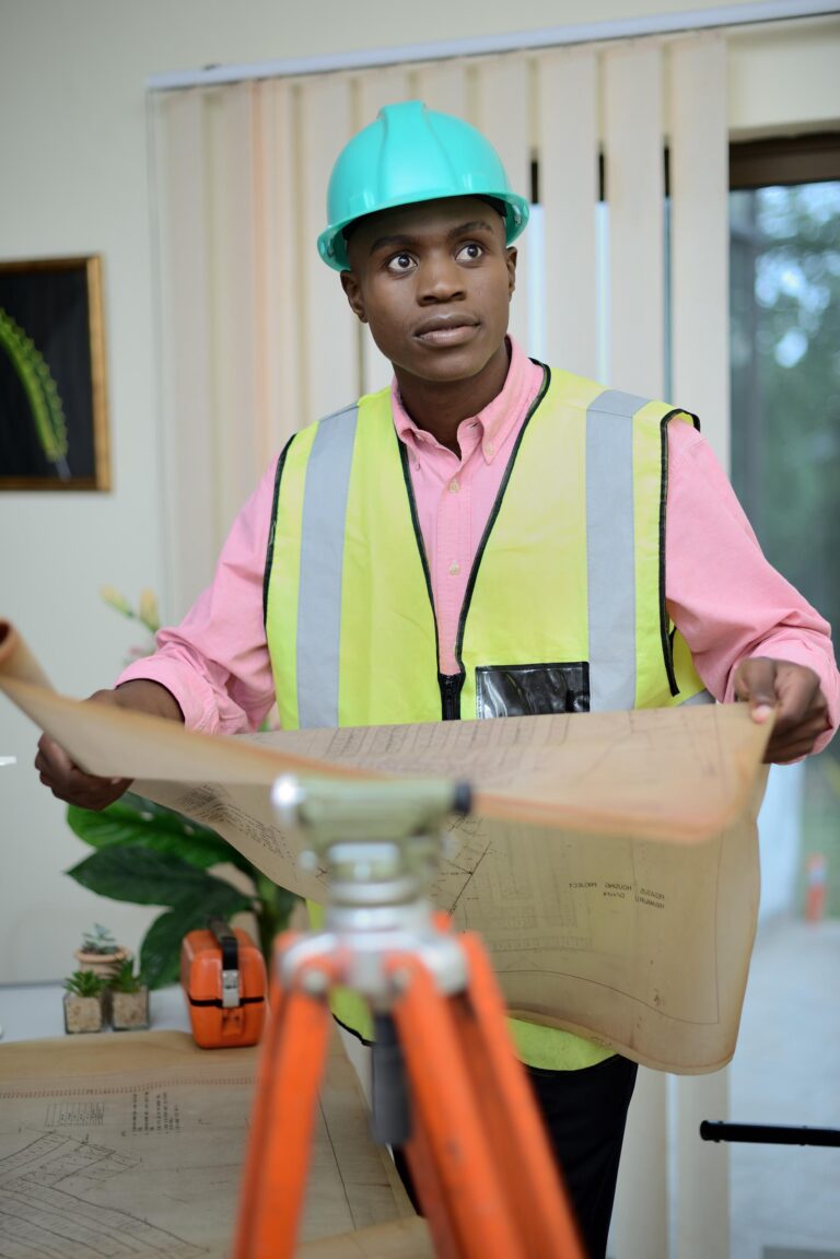 picture of an engineer holding a house plan.